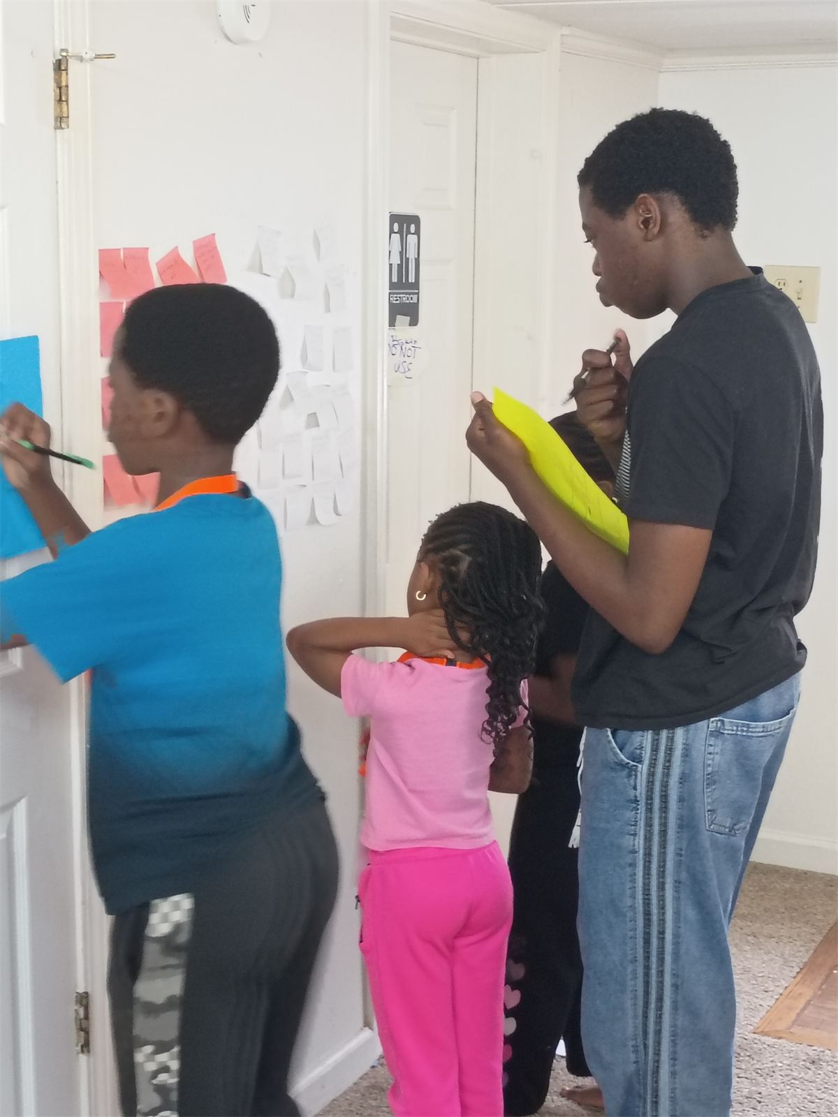 Founders adding ideas to a wall of problem notes during Founders Lab